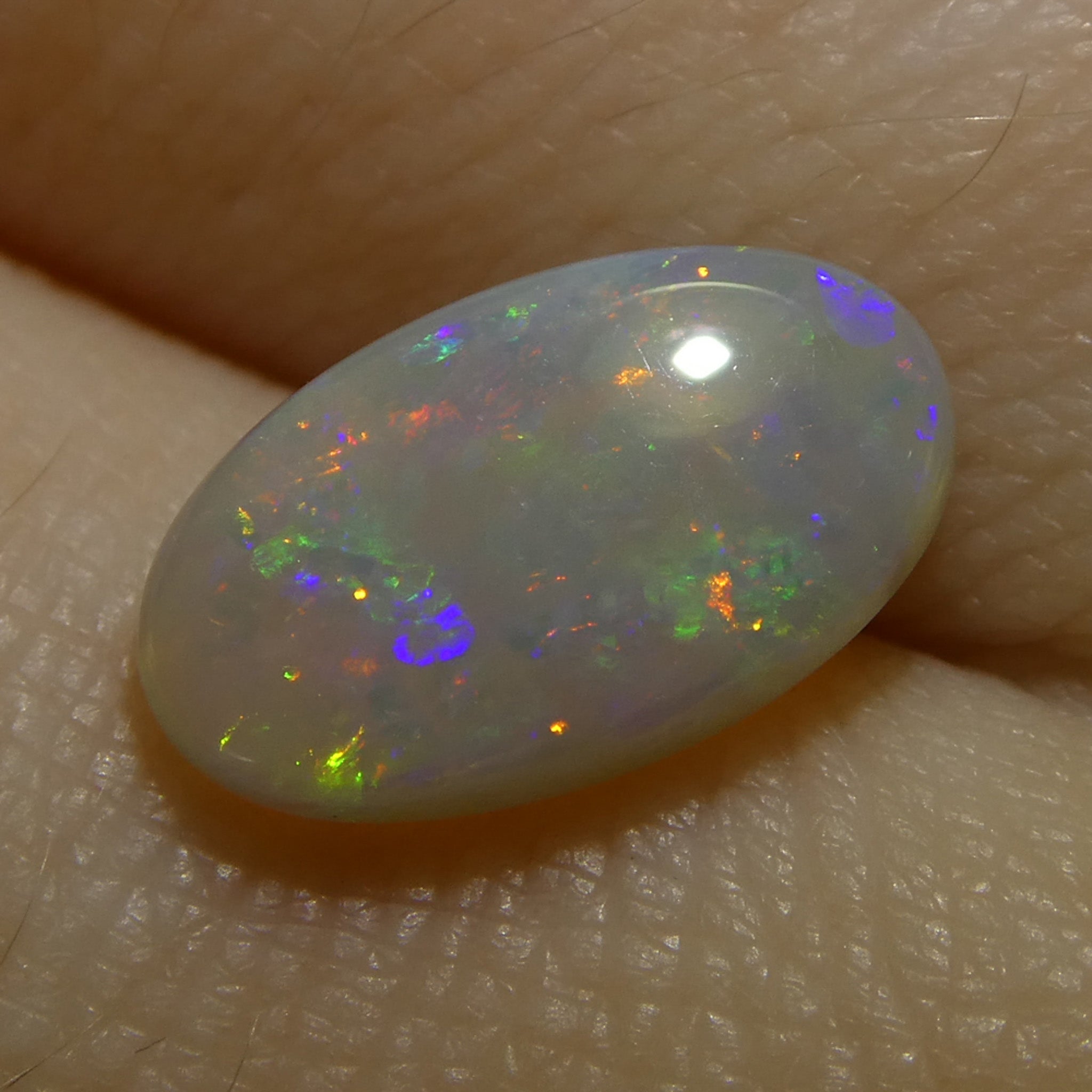 1.32ct White Oval Cabochon Opal from Australia with Play of Color, premium gemstone by SkyJems Canadian gem specialists