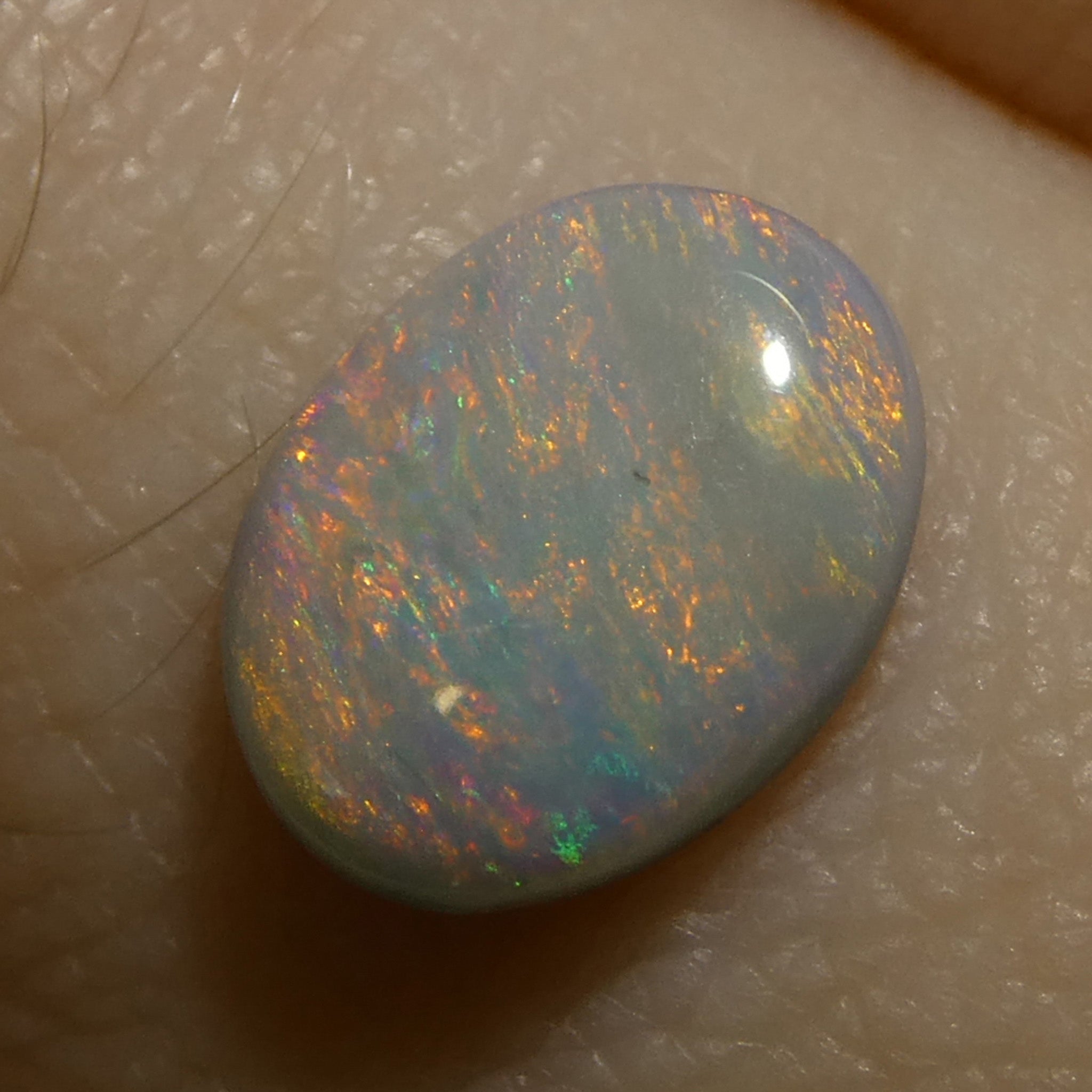 0.67ct Gray Oval Cabochon Opal from Australia with Play of Color, premium gemstone by SkyJems Canadian gem specialists