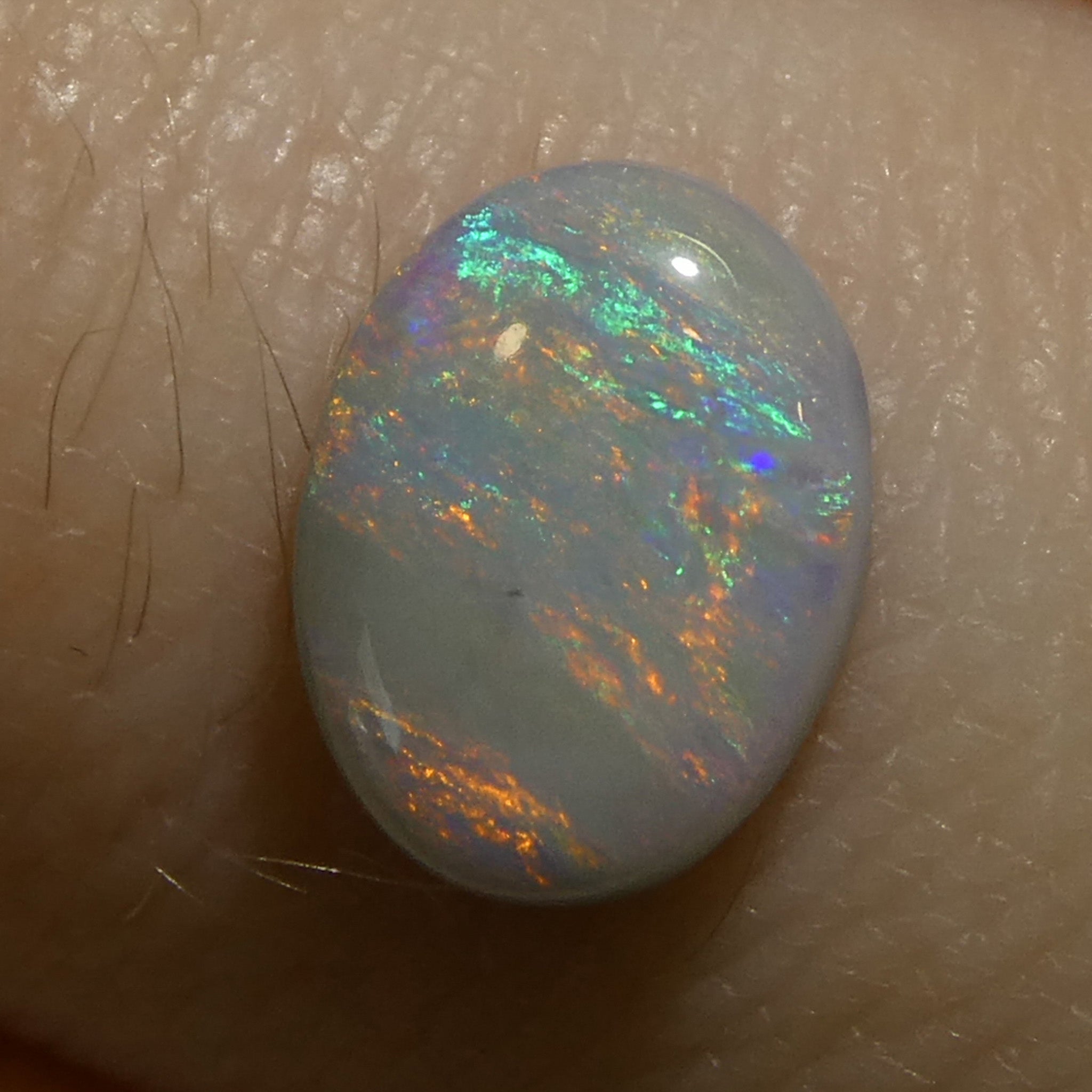 0.67ct Gray Oval Cabochon Opal from Australia with Play of Color, premium gemstone by SkyJems Canadian gem specialists
