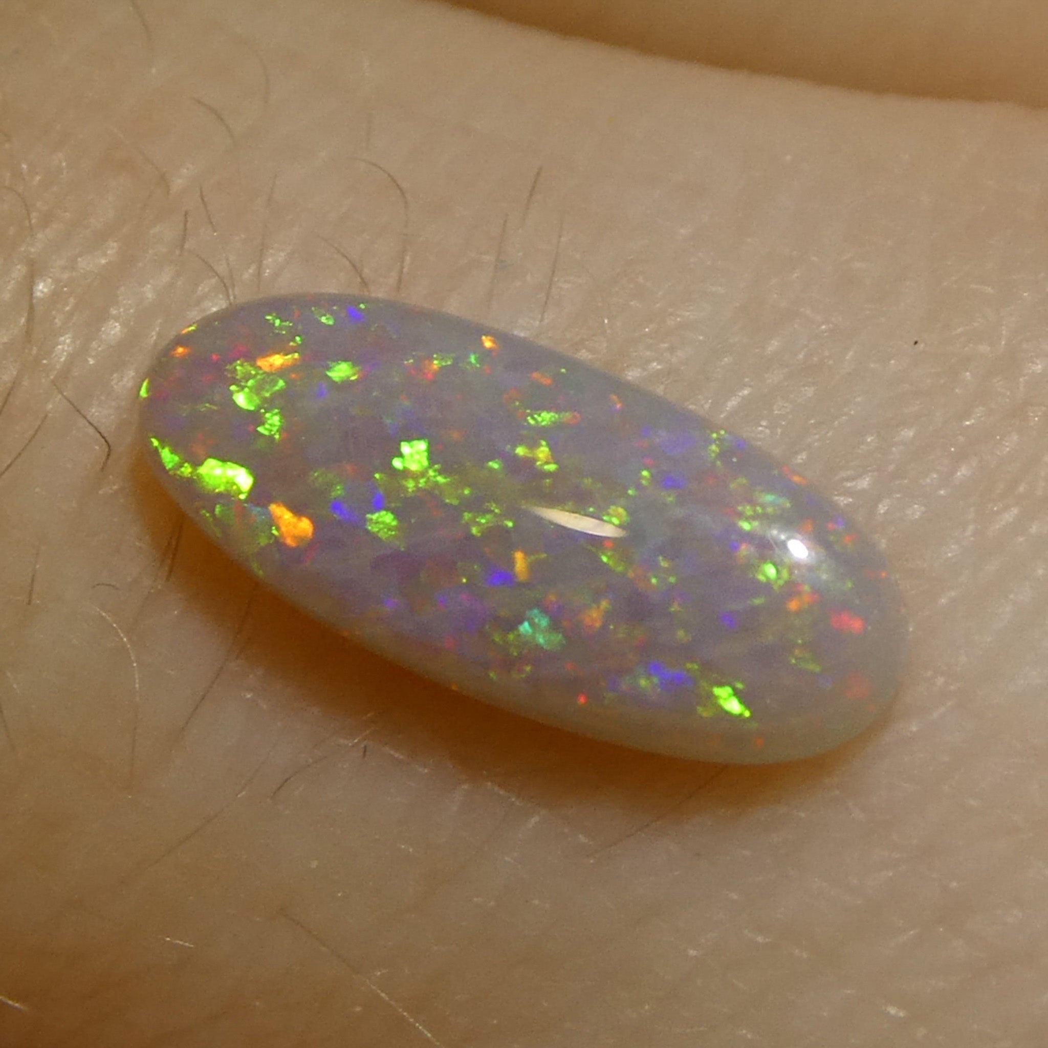 0.62ct White Opal Cabochon with Play of Color from Australia, premium gemstone by SkyJems Canadian gem specialists
