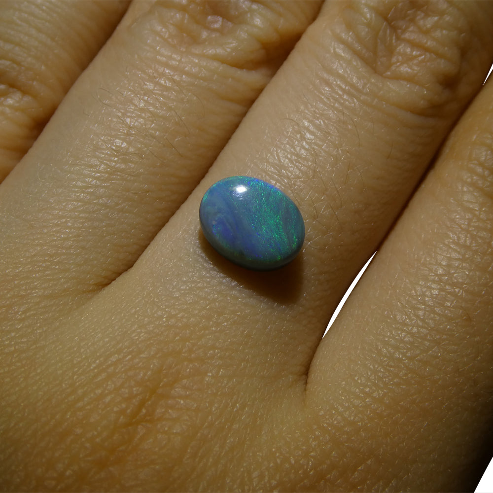 1.53ct Australian Black Opal with vibrant play of color, oval cabochon cut - premium gemstone from SkyJems' curated collectio