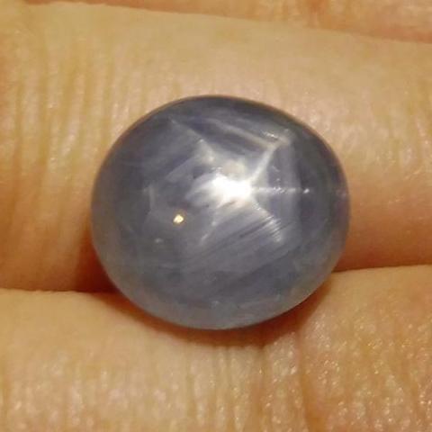 Blue oval star sapphire 6.86 ct from Sri Lanka, showcasing asterism effect, premium gemstone by SkyJems Canadian gem speciali