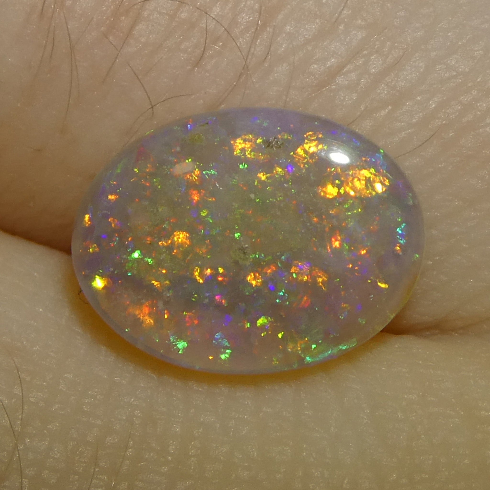 1.54ct White Oval Cabochon Opal from Australia with Play of Color, premium gemstone by SkyJems Canadian gem experts