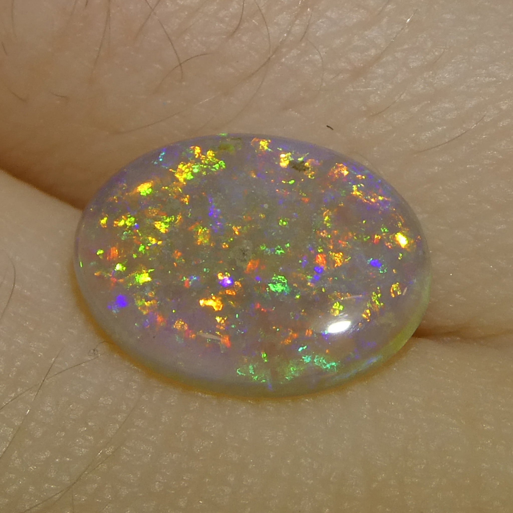 1.54ct White Oval Cabochon Opal from Australia with Play of Color, premium gemstone by SkyJems Canadian gem specialists