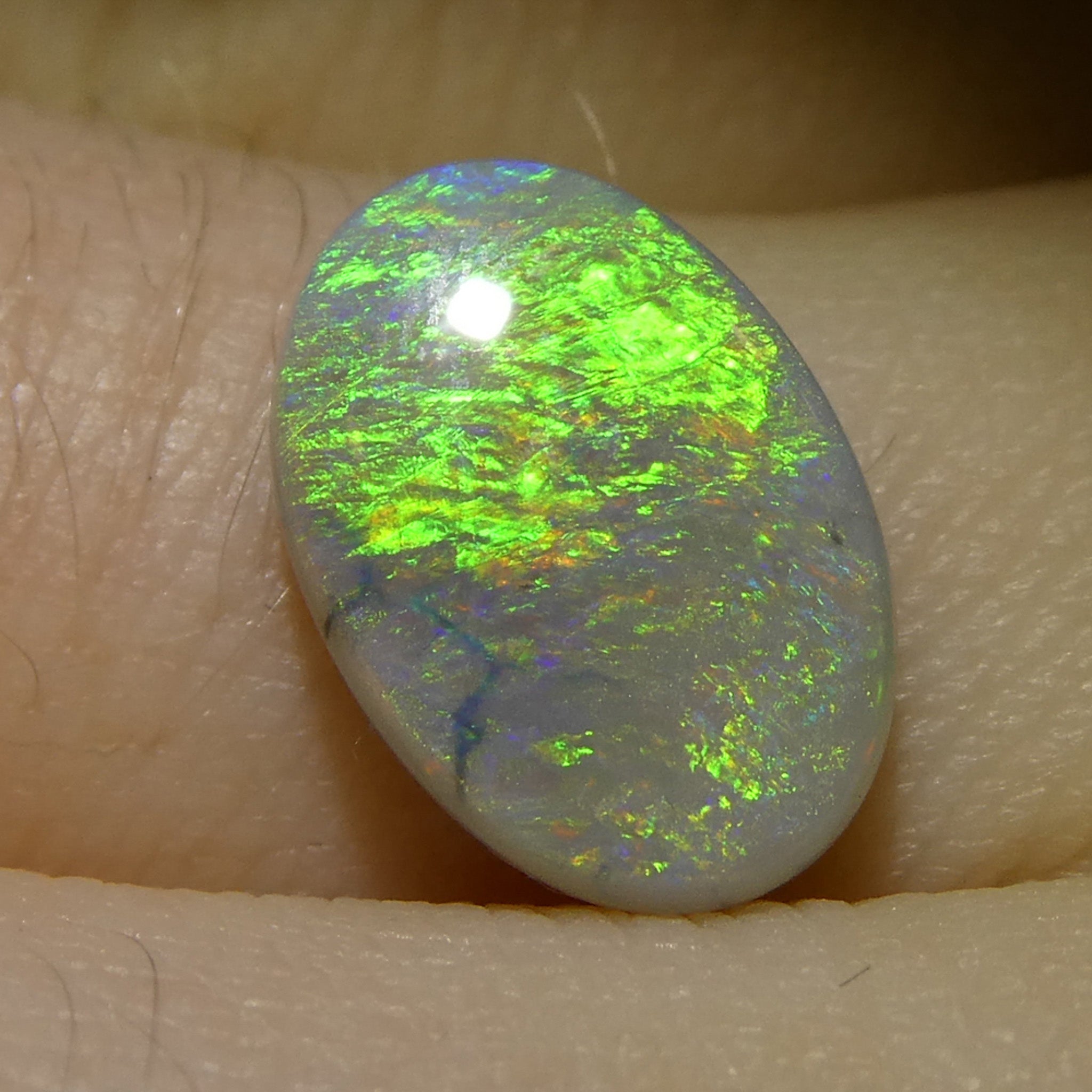 2-carat oval gray Australian opal cabochon from SkyJems, showcasing subtle play of color and premium gemstone quality