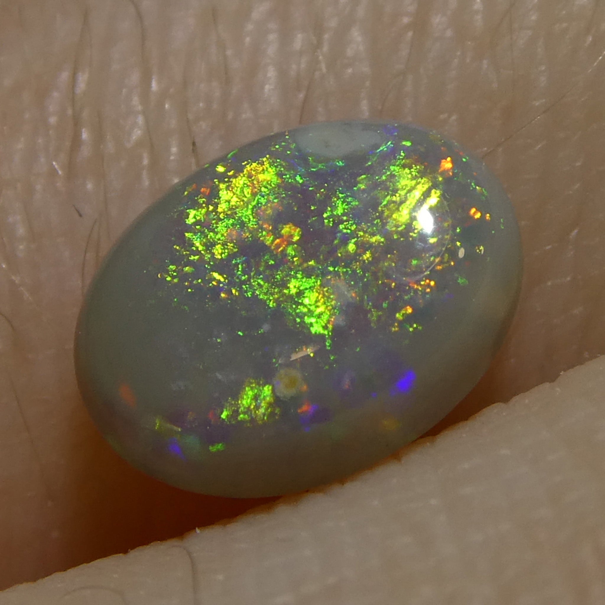 0.72ct Oval Gray Opal from Australia, natural cabochon gemstone with play of color by SkyJems Canadian gem experts