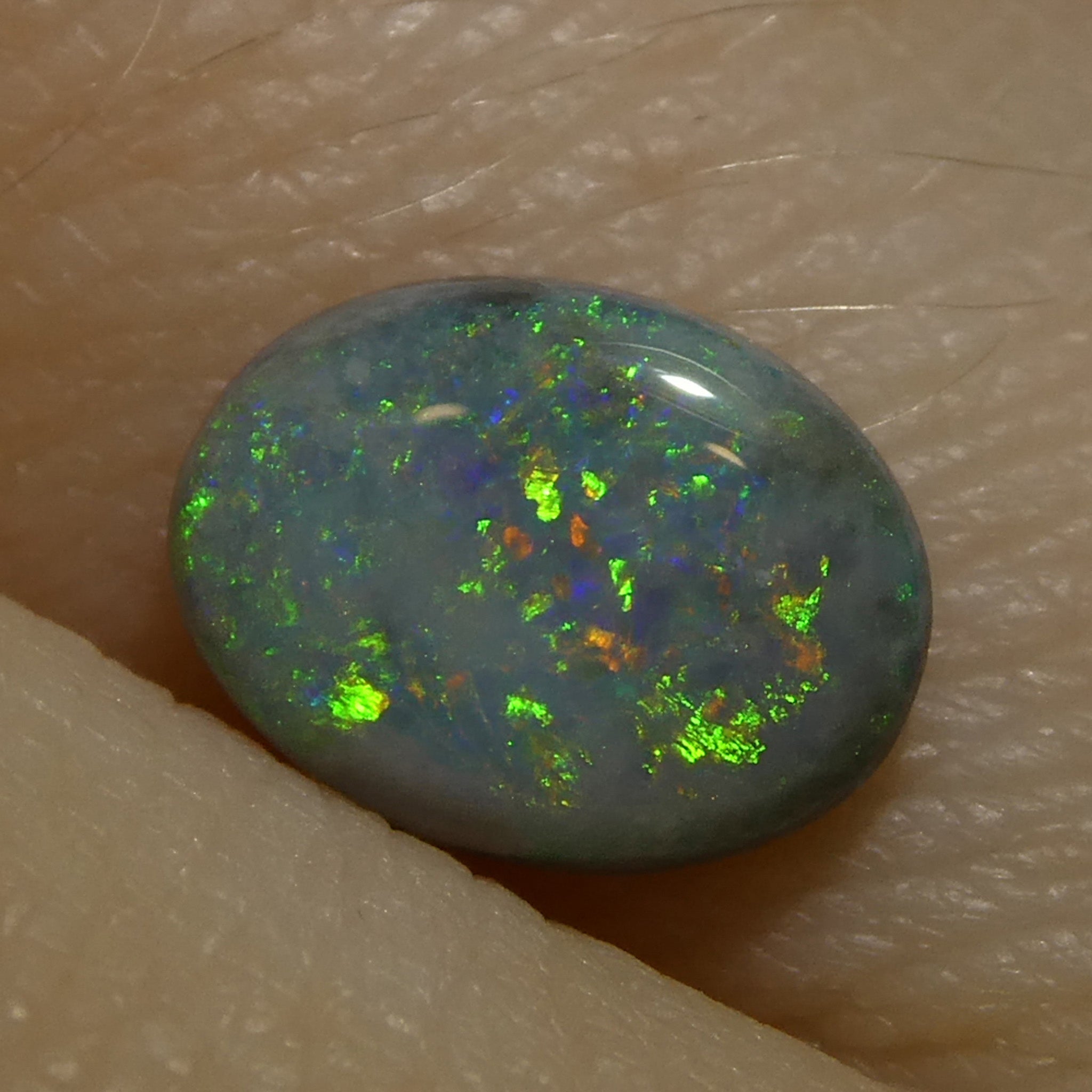 0.64ct Gray Oval Cabochon Opal from Australia with play of color, premium gemstone by SkyJems Canadian gem specialists