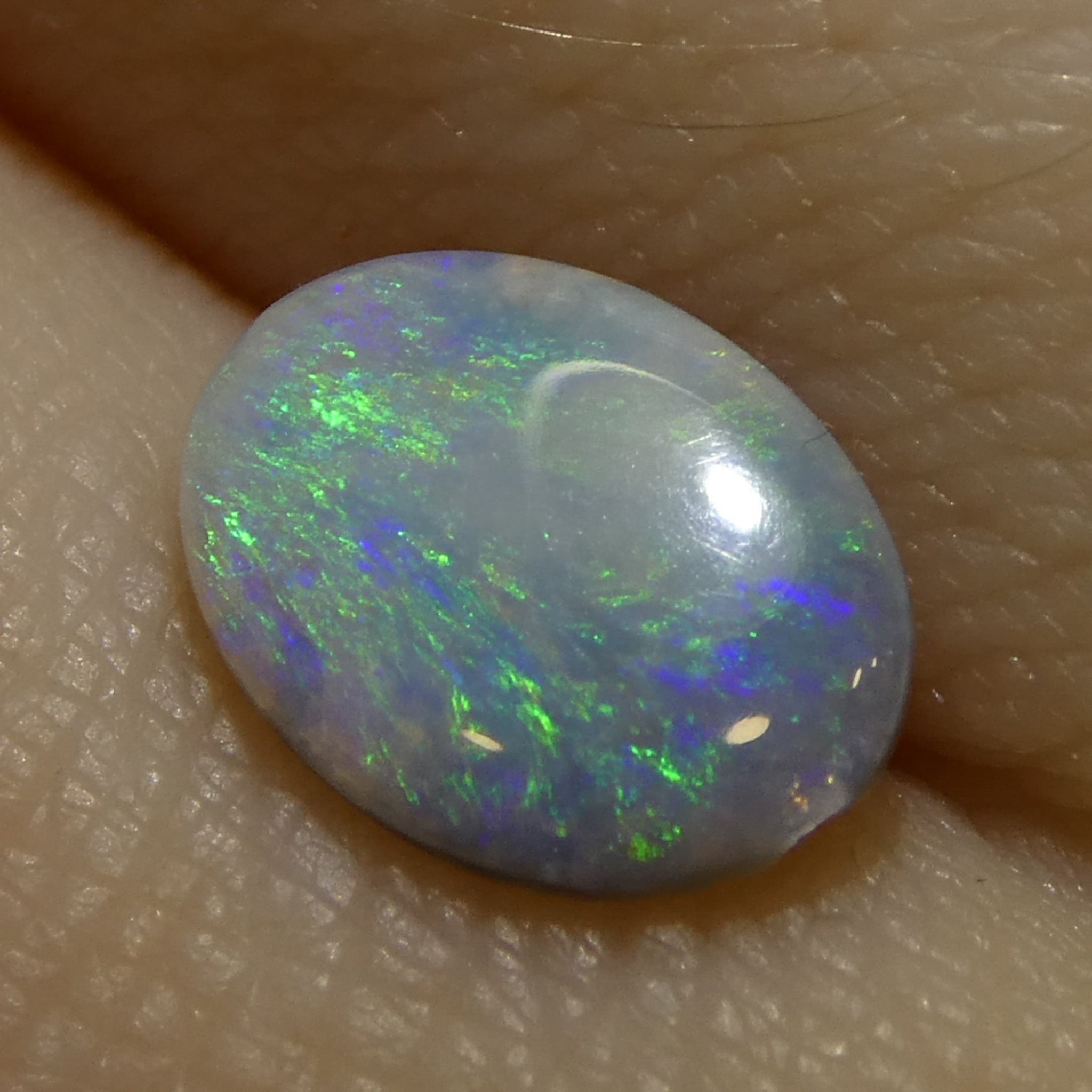 0.47ct White Oval Cabochon Opal from Australia with Play of Color, premium gemstone by SkyJems Canadian gem experts