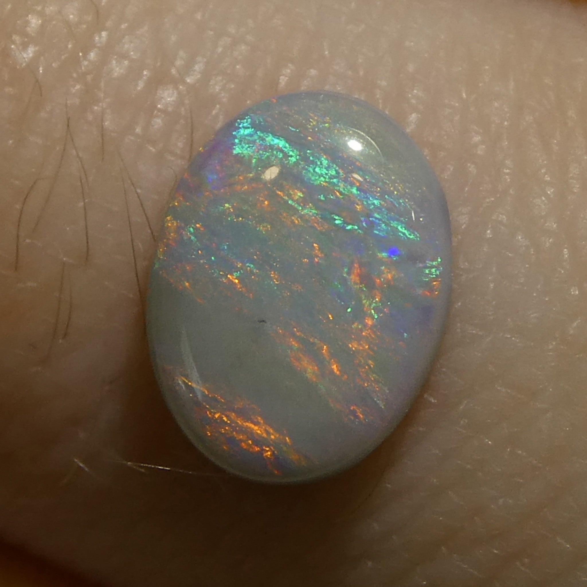 0.67ct Gray Oval Cabochon Opal from Australia with Play of Color, premium gemstone by SkyJems Canadian gem specialists