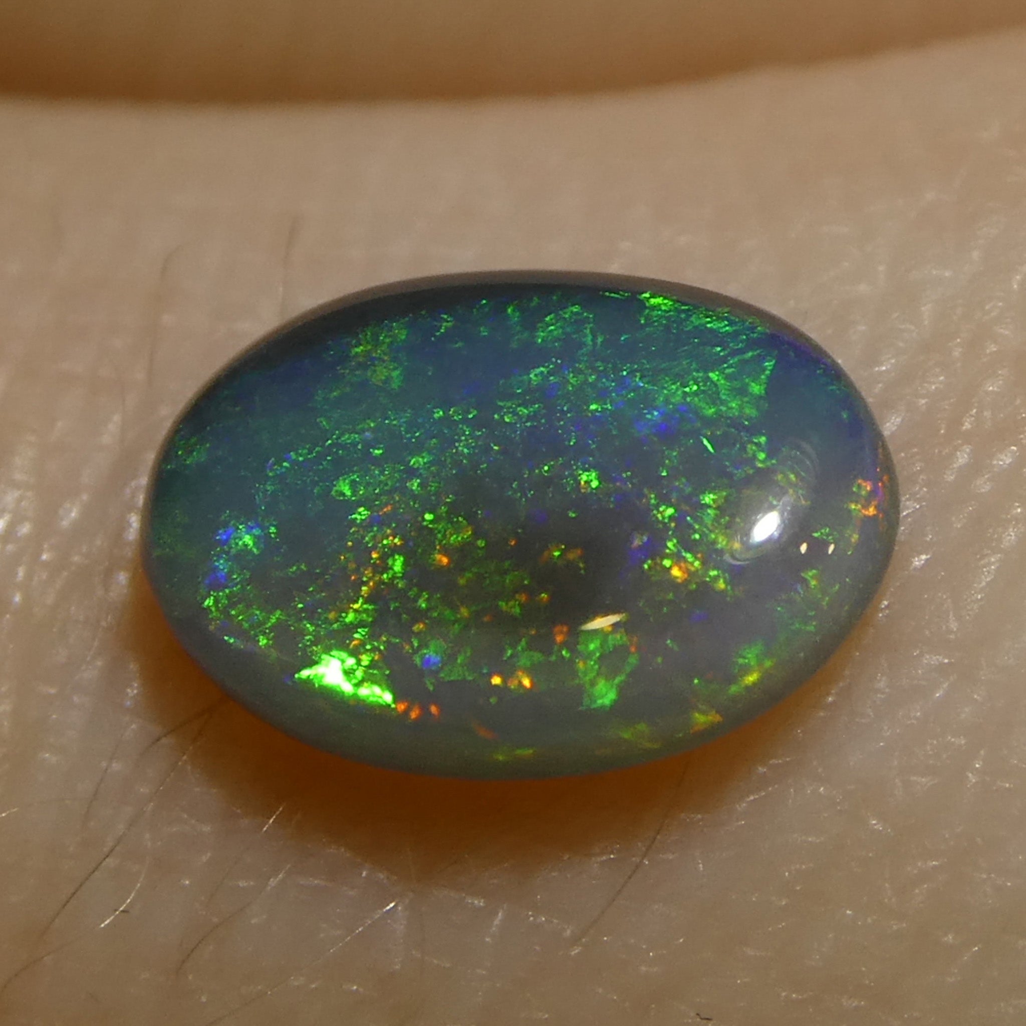 0.59ct Gray Oval Cabochon Opal from Australia with Play of Color, premium gemstone by SkyJems Canadian gem specialists