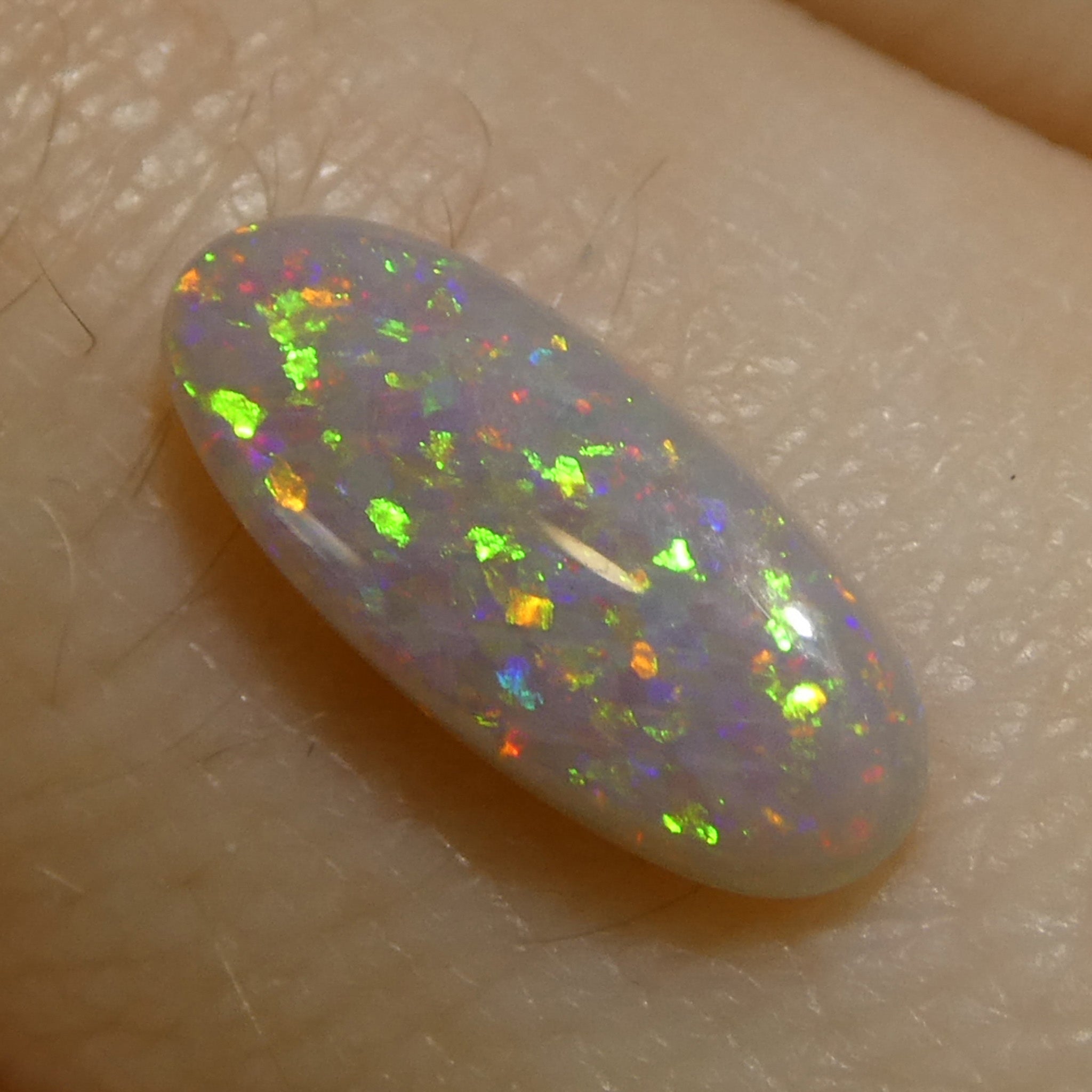 0.62ct White Opal Cabochon with Play of Color from Australia, premium gemstone by SkyJems Canadian gem specialists