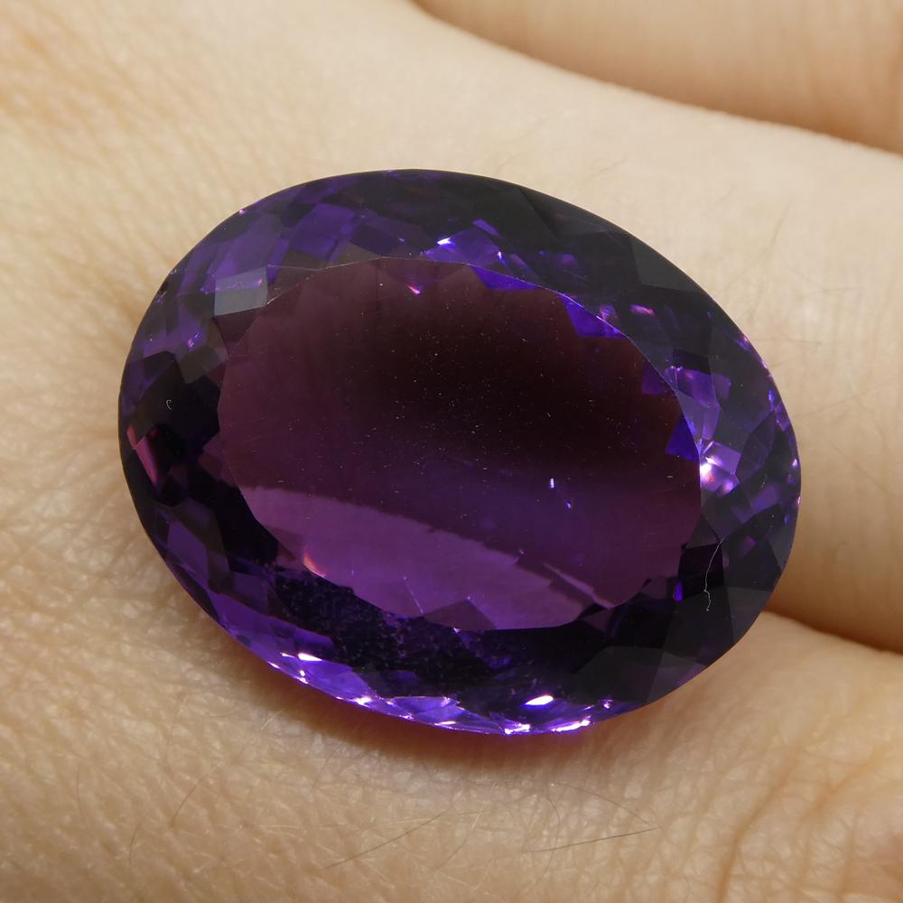 Large 25.37 ct purple Brazilian Amethyst oval gemstone from SkyJems, showcasing brilliant cut and rich violet hue