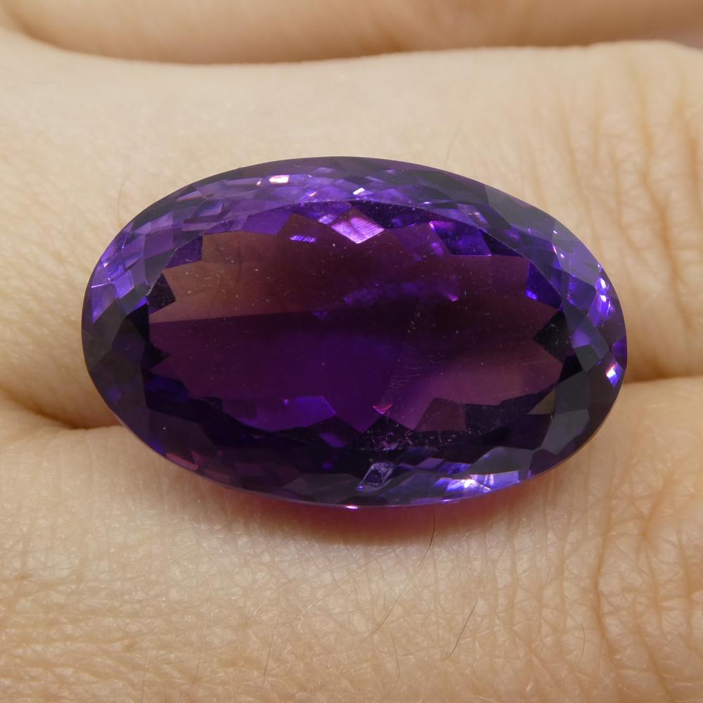 Large 21.55 ct purple Brazilian Amethyst oval gemstone from SkyJems, showcasing brilliant cut and rich violet hue