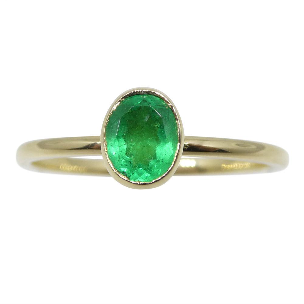 Dainty Colombian emerald stacker ring in 10kt yellow gold, handcrafted by SkyJems Canadian jewellers, oval green gemstone sol