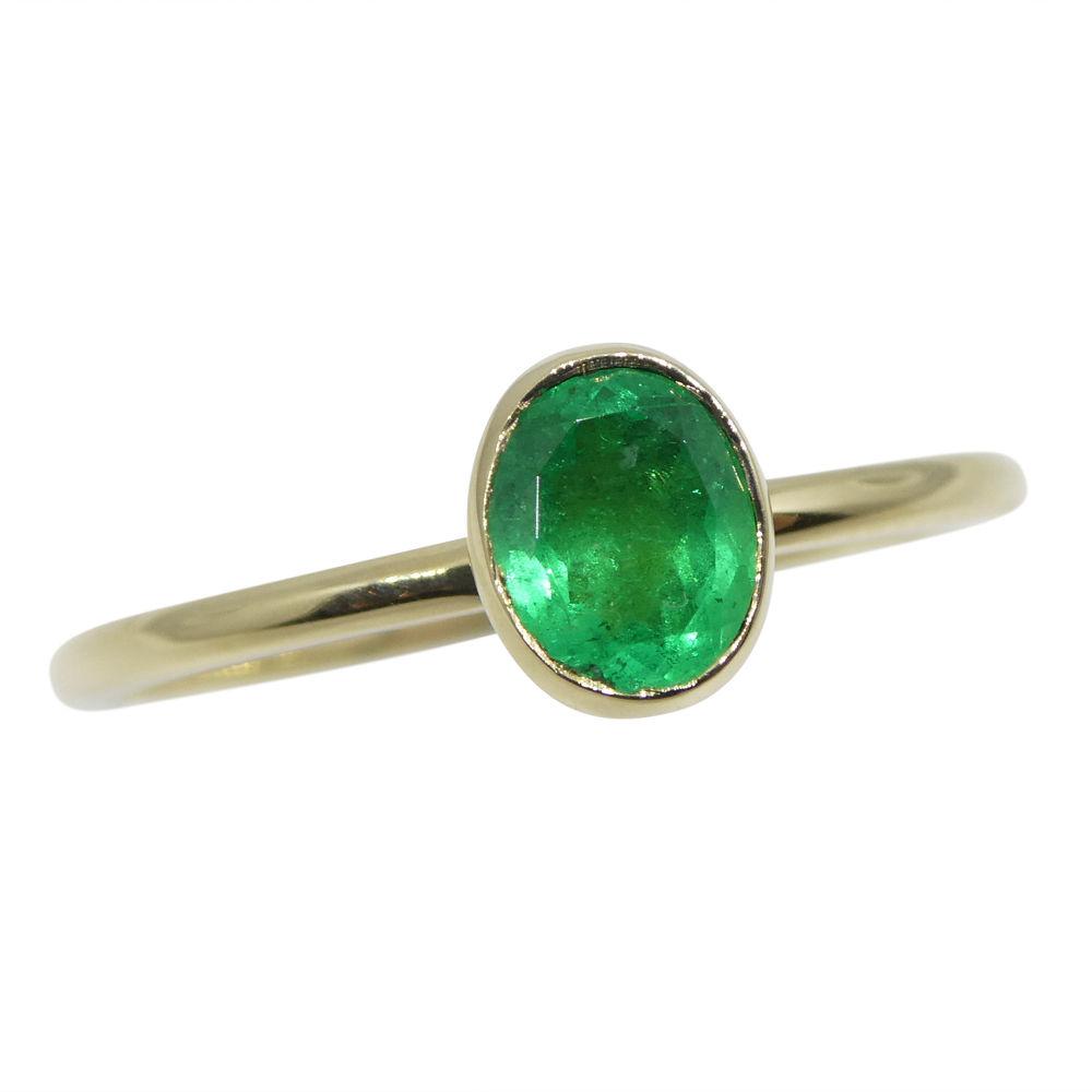 Dainty Colombian emerald stacker ring in 10kt yellow gold, handcrafted by SkyJems Canadian jewellers, oval green gemstone sol