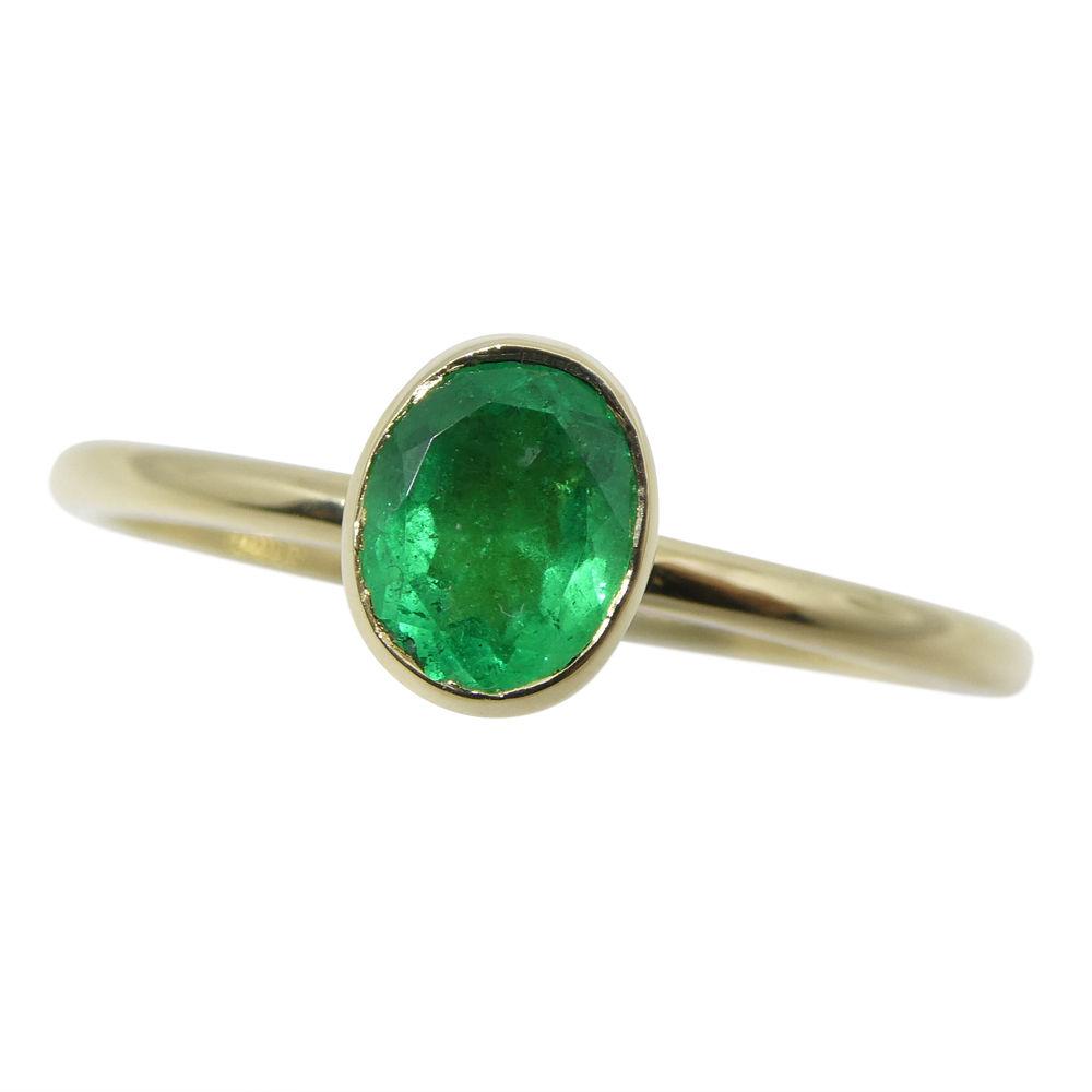 Dainty Colombian emerald stacker ring in 10kt yellow gold, handcrafted by SkyJems Canadian jewellers, elegant green gemstone 