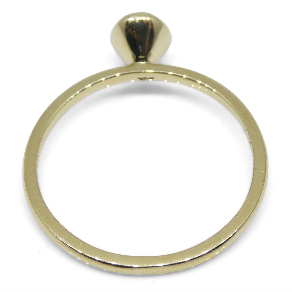 Dainty Colombian emerald stacker ring in 10kt yellow gold, handcrafted by SkyJems Canadian jewellers, oval green gemstone sol