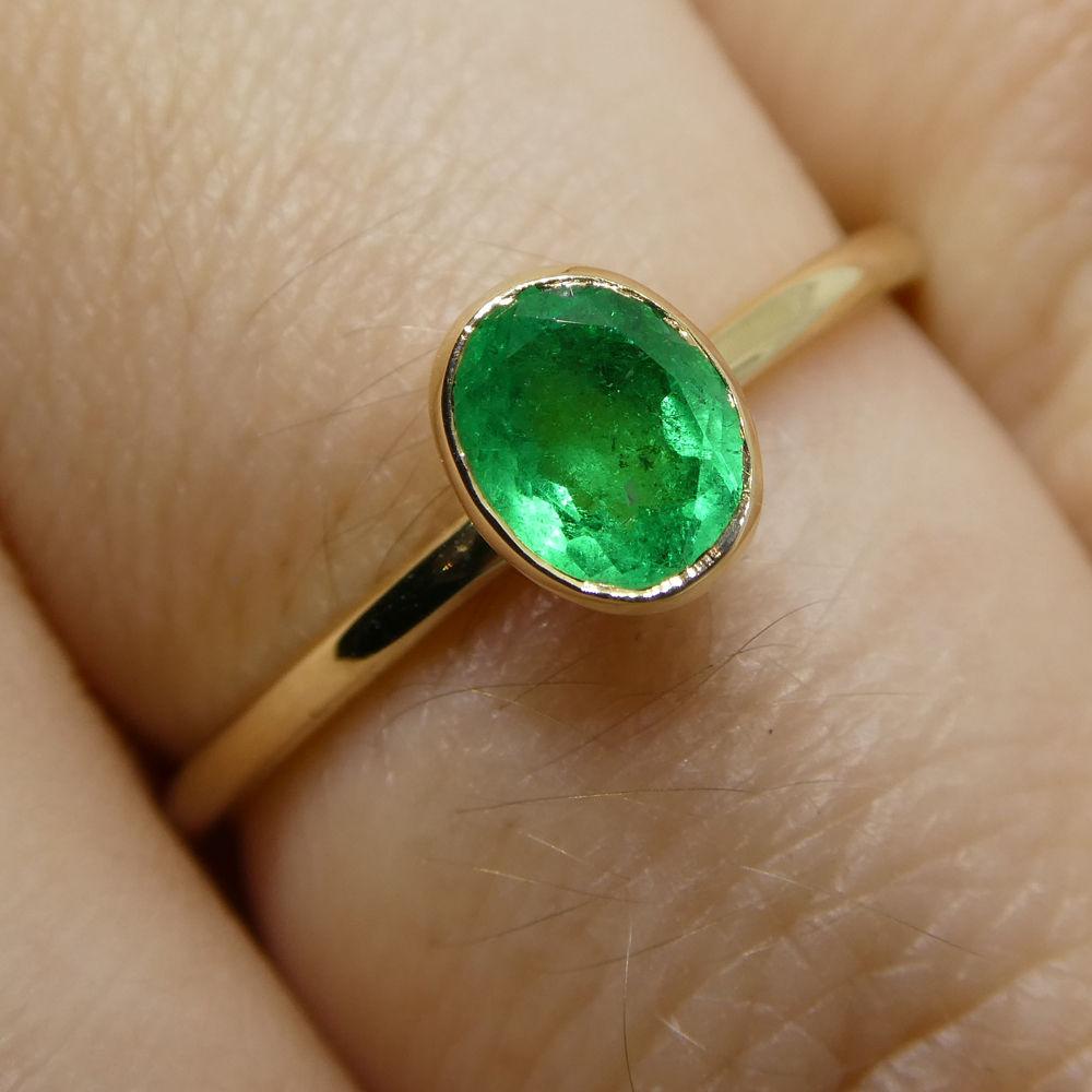 Dainty Colombian emerald stacker ring in 10kt yellow gold, handcrafted by SkyJems Canadian jewellers, oval green gemstone sol