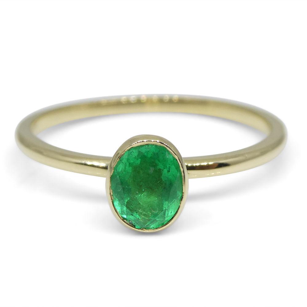 Dainty Colombian emerald oval stacker ring in 10kt yellow gold, handcrafted by SkyJems Canadian jewellers since 1967