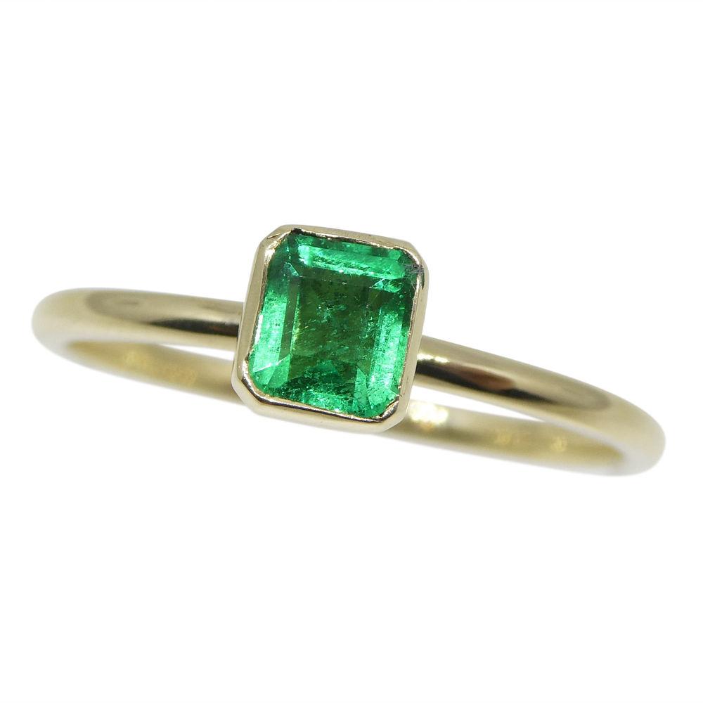 Dainty Colombian emerald stacker ring in 10kt yellow gold, handcrafted by SkyJems Canadian jewellers, green gemstone solitair