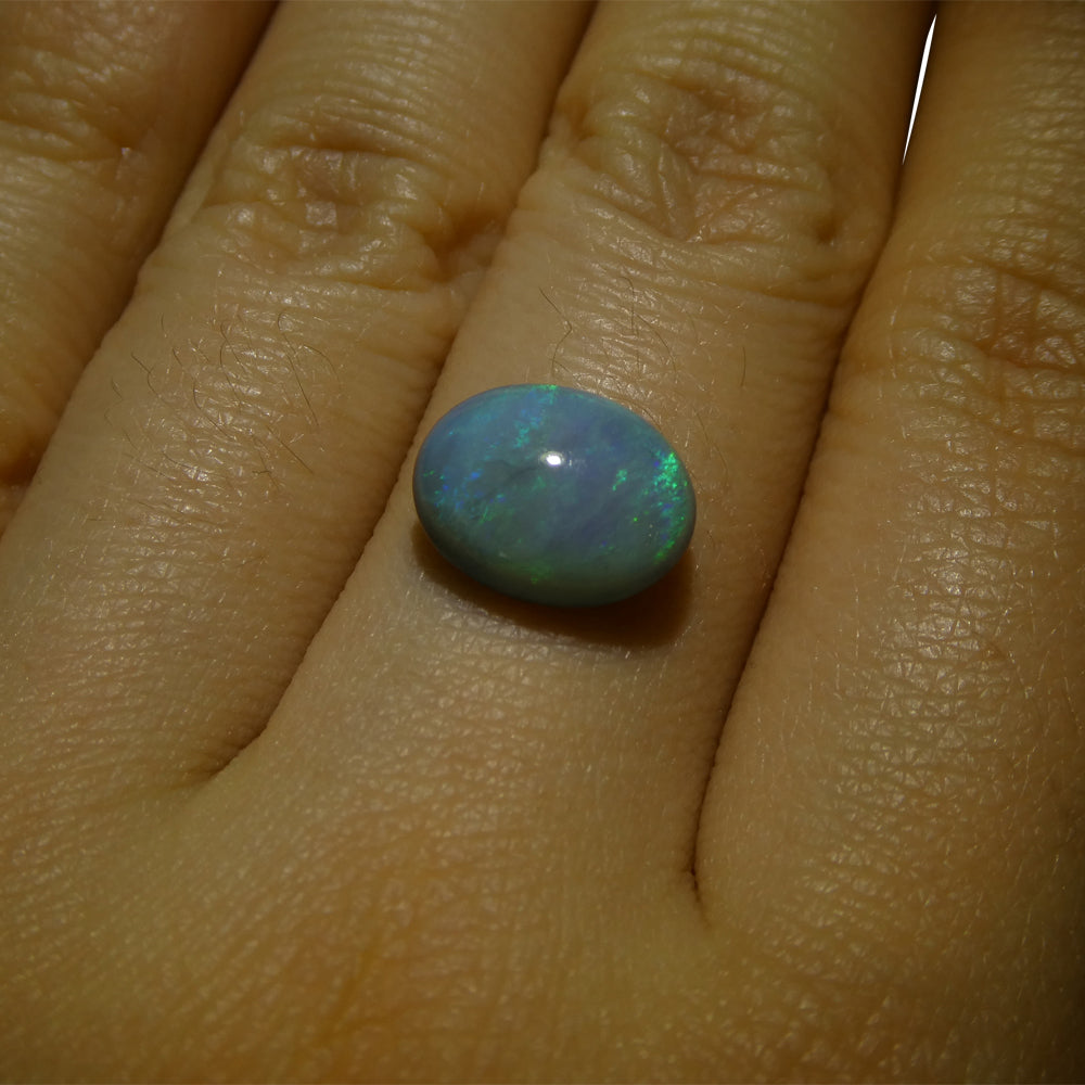 2.37ct Australian Black Opal with vibrant play of color, oval cabochon cut - premium gemstone from SkyJems Canadian gem exper