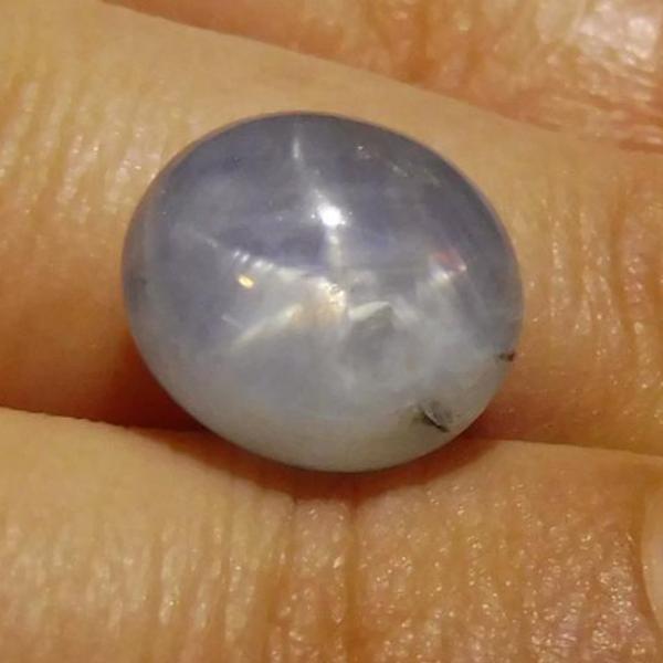 SkyJems 7.67 ct Blue Oval Star Sapphire from Sri Lanka, showcasing rare asterism effect in classic gemstone shape