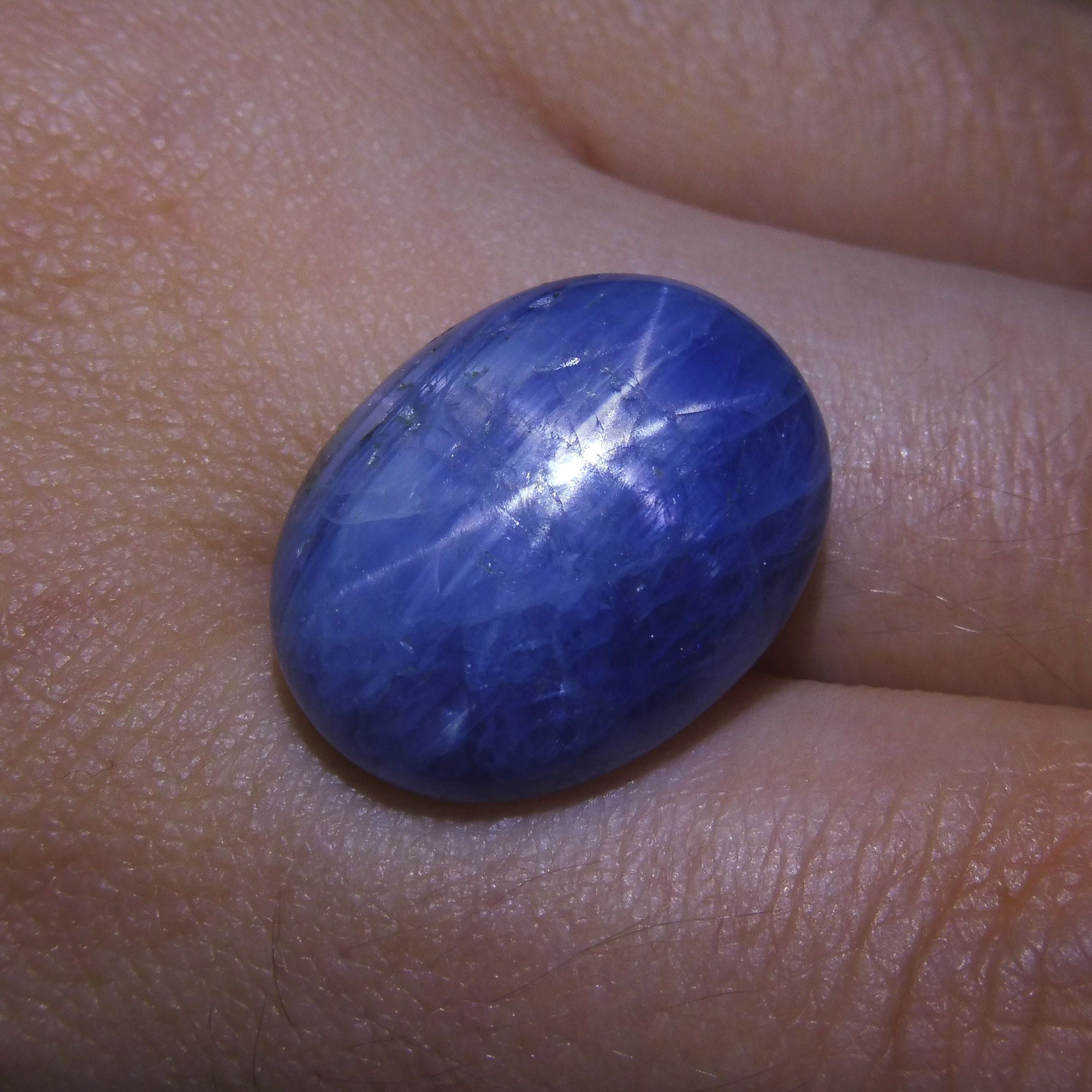 Blue oval star sapphire from Myanmar, 25 carats, showcasing rare asterism effect, premium gemstone by SkyJems Canadian gem sp